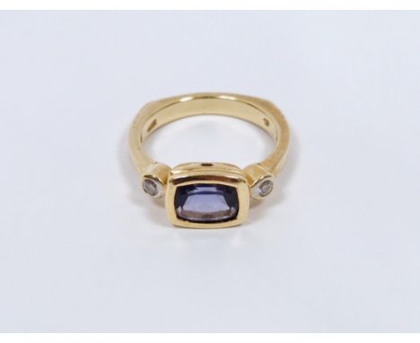 14K gold, blue and white stone dress ring, the rectangular cut stone probably a sapphire flanked by two small diamonds, all i