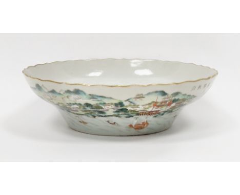 Chinese porcelain famille verte shallow bowl with gilt wavy rim, the sides painted in enamels with a scene of boats on water 