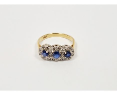Gold-coloured metal, blue and white stone triple oval cluster ring set three oval blue stones, probably sapphires, surrounded