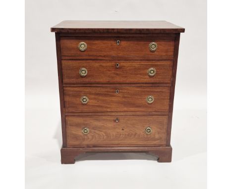 Reproduction Georgian mahogany small chest of four long drawers with brass ring drop handles and raised on bracket feet, 62cm