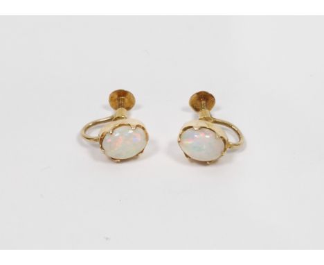 Pair of 18ct yellow gold and opal earrings, each earring holding an oval claw set white opal of approximately 0.9cm length, t