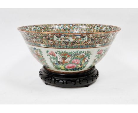 Late 19th/early 20th century Chinese famille rose porcelain bowl&nbsp;raised on a carved wooden stand, the bowl 38cm diameter