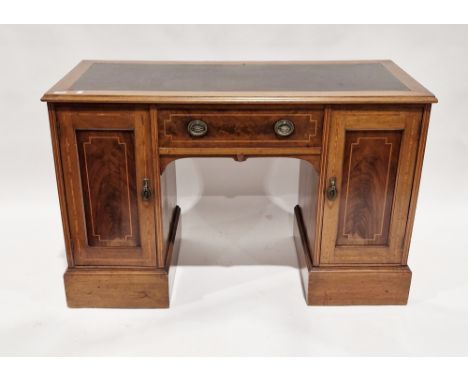 Edwardian mahogany kneehole desk with simulated leather inset top and ogee moulded edge, the single drawer and two cupboard d