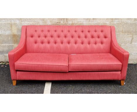 Multi York sofa&nbsp;upholstered in a red fabric with button back, curved arms and two seat cushions, raised on square wooden