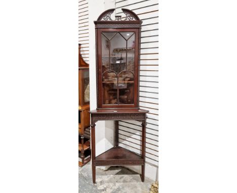 Edwardian mahogany corner cabinet in the George lll manner, the upper section with pierced broken pediment over a single astr