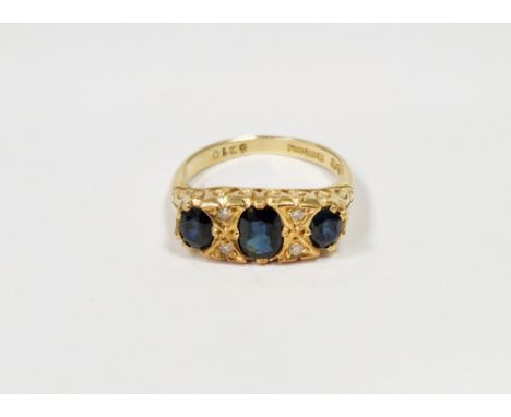 18ct gold, sapphire and diamond dress ring set three oval sapphires interspersed with four small diamonds, in pierced scroll 