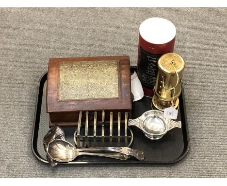 A tray of brass miner's lamp, trinket box, silver plated ladles, quaich and toast rack 