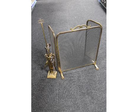 An antique brass three way folding fire screen together with a brass companion set 