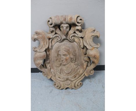 A heavily carved oak wall plaque or crest, a relief female portrait within scrolls and eagle heads  CONDITION REPORT: 18th ce