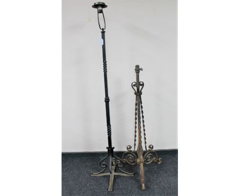 An antique cast iron standard lamp together with a cast iron oil lamp base 