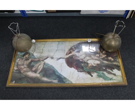 A large gilt framed print of Michelangelo's Creation of Adam together with a pair of contemporary brass bulbous table lamps 