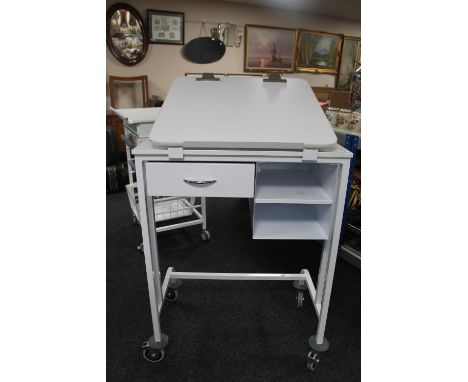 A metal medical trolley fitted with drawers with adjustable shelf