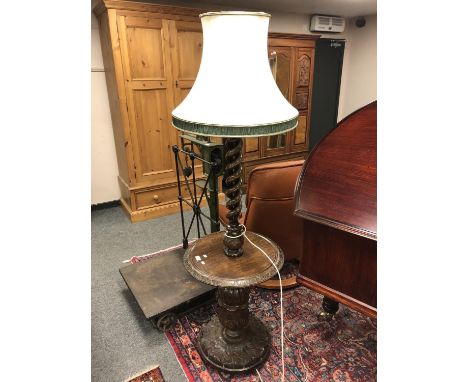 An Edwardian carved oak standard lamp 