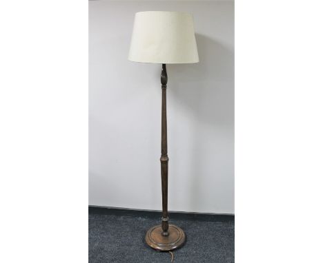 An early twentieth century oak standard lamp with shade (no plug)