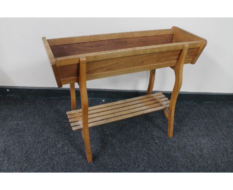 A teak plant trough with under shelf 