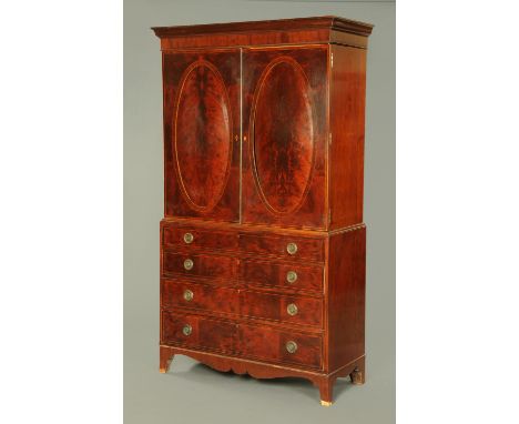 A 19th century mahogany gentleman's wardrobe, with detachable moulded cornice above a pair of panelled cupboard doors opening