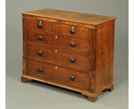 A 19th century oak chest of drawers, with two short and three long graduated drawers with ebonised knob handles and cockbeadi