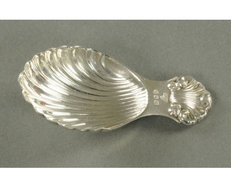A silver caddy spoon, scallop shaped, London 1989.