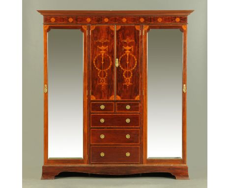 An Edwardian inlaid mahogany wardrobe, with detachable moulded cornice above a pair of doors enclosing shelves and with drawe