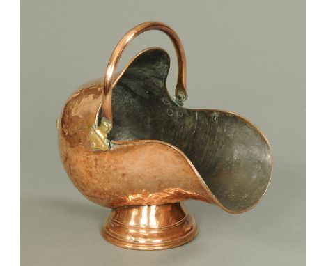 A Victorian planished copper coal helmet.