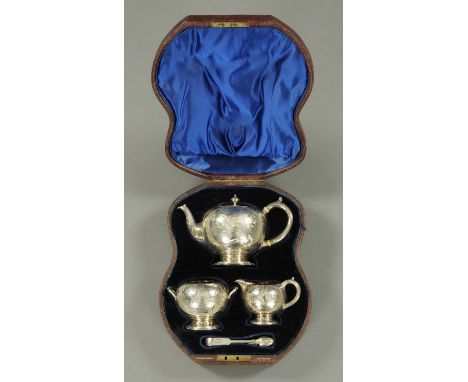 An Elkington & Co. Victorian Chinoiserie silver tea service, teapot, sugar basin, milk jug and tongs, London 1868, Silversmit