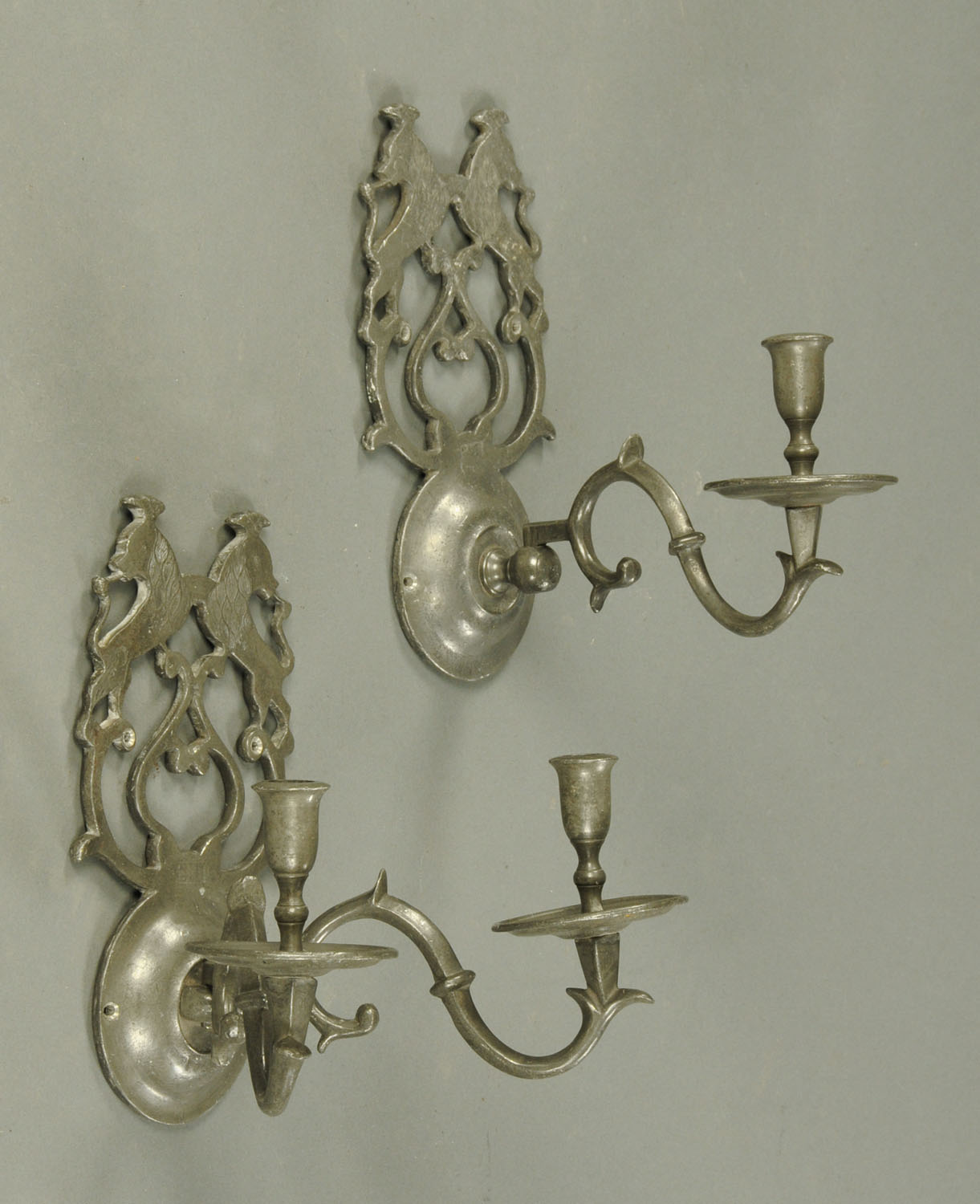 Two 18th century heavy pewter wall sconces, one double candle holder