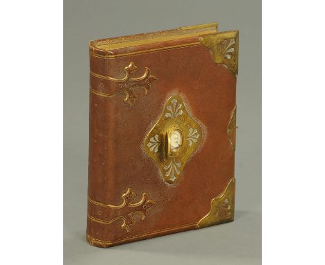 A Victorian leather bound musical photograph album, with black and white family photographs.  29 cm x 23 cm.   CONDITION REPO