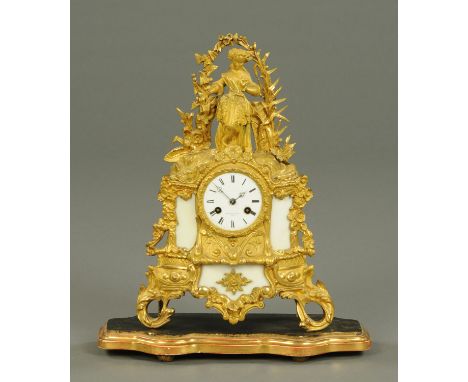 A 19th century French gilt metal mantle clock, the dial marked "Pearce & Sons, Paris" and raised on a wooden base.  Overall h