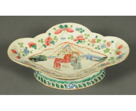 A Chinese raised dish, shaped outline, decorated with figures in polychrome.  Length 24 cm.    CONDITION REPORT:  This lot is