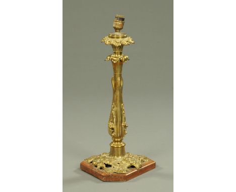 A Victorian brass oil lamp base, raised on a wooden plinth.  Height excluding light fitting 47 cm.    CONDITION REPORT:  The 