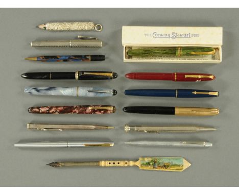 A collection of vintage pens and pencils.