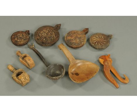 A collection of 19th century Treen, including moulds (5), nutcracker, ladle and scoop.  Longest 28 cm. 