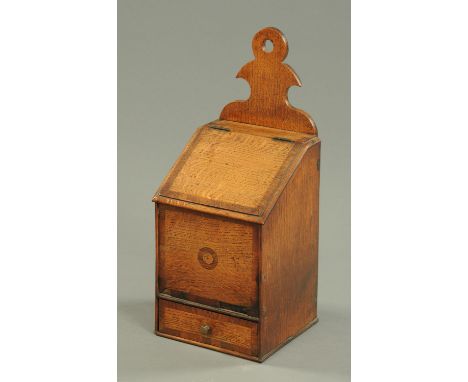 A George III oak and mahogany crossbanded candle box, with slope front and drawer.  Height 42 cm.    CONDITION REPORT:  Other