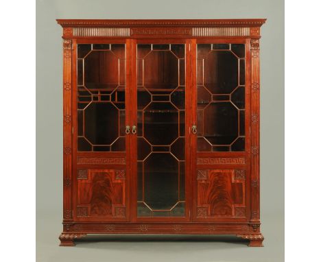 A late Victorian mahogany gun cabinet, converted to a display case, with detachable moulded dentil and Greek key cornice abov