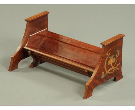 An Arts & Crafts mahogany book trough, inlaid with brass and pewter with stylised designs, Registration No. 353733.  Width 44