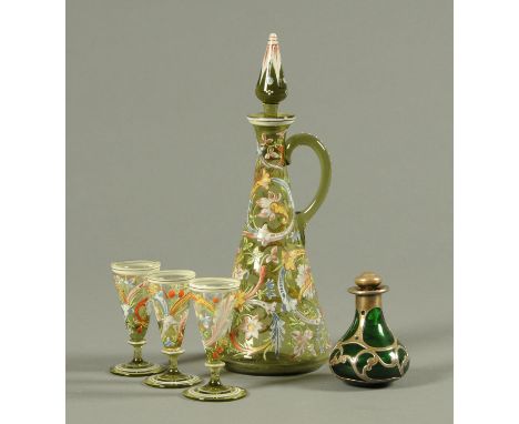 An enamelled green glass decanter, with three glasses, and a silver mounted scent bottle.    CONDITION REPORT:  Decanter is i