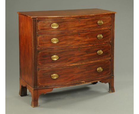 An early 19th century mahogany bowfronted chest of four drawers, with brass drop handles,oval backplates, boxwood and ebony s