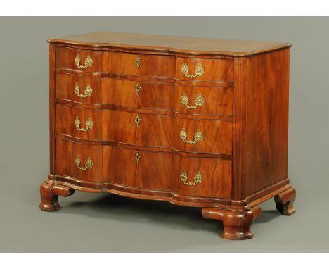 An 18th century mahogany commode chest of drawers, probably Dutch, with serpentine front, four frieze drawers with brass drop