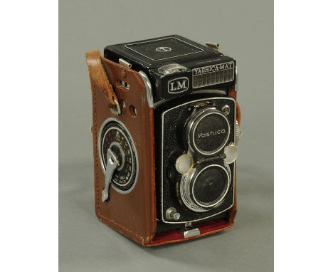 A Yashica-Mat camera with accessories.