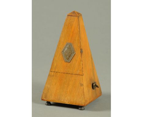A French walnut metronome, by Paquet.  Height 22.5 cm. 