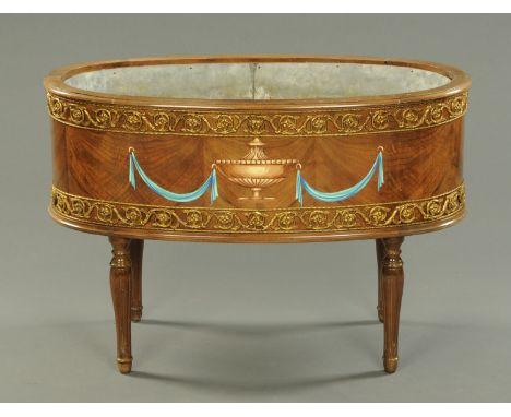 A Continental painted and gilt oval plant trough, with galvanised tin liner and raised on four turned and fluted legs.  Width