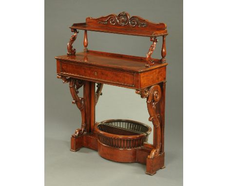 A Victorian mahogany console table, with rear carved and shelved upstand, frieze drawer and with scroll supports with rear mi