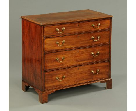 A late George III mahogany chest of drawers, with four long graduated drawers with brass drop handles and raised on bracket f