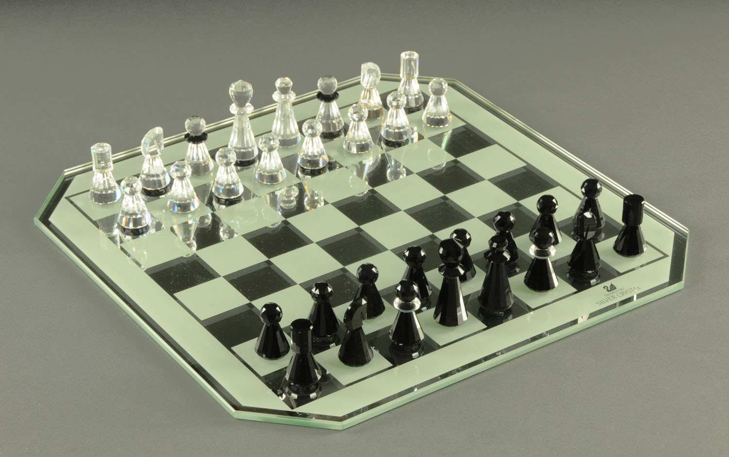 A Swarovski crystal chess set, complete with chessboard and case, boxed ...