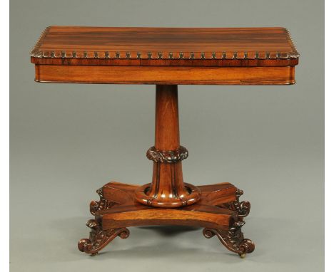 A William IV rosewood turnover top card table, with moulded edge, baize lined playing surface, centre column, quatreform base