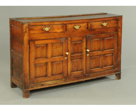 A 19th century oak dresser base, fitted with a series of drawers and cupboards and raised on bracket feet.  Width 154 cm (see