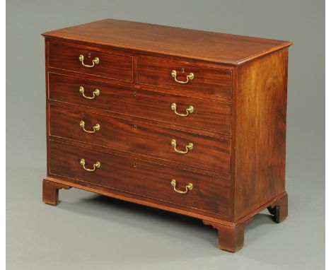 A George III mahogany chest of drawers, with moulded edge above two short and three long graduated drawers with brass swans n