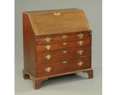 A George III oak bureau, with slope front to fitted interior and well, with three graduated drawers beneath the false drawer 