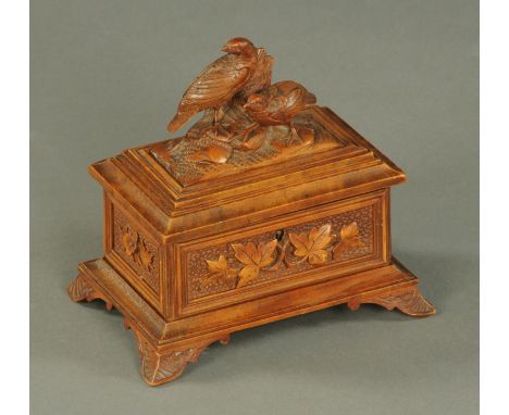 A small Black Forest casket, with hinged lid with game birds and raised on bracket feet.  Width 18 cm. 