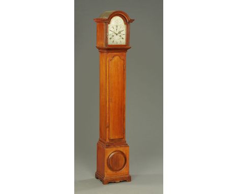 A mahogany grandmother clock, with silvered brass dial and two-train striking movement, with long trunk door and raised on br